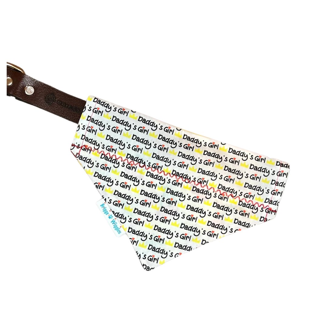 Daddy's Girl reversible Dog Bandana displayed on a collar, showcasing a white background with yellow and black lettering and red heart detail.