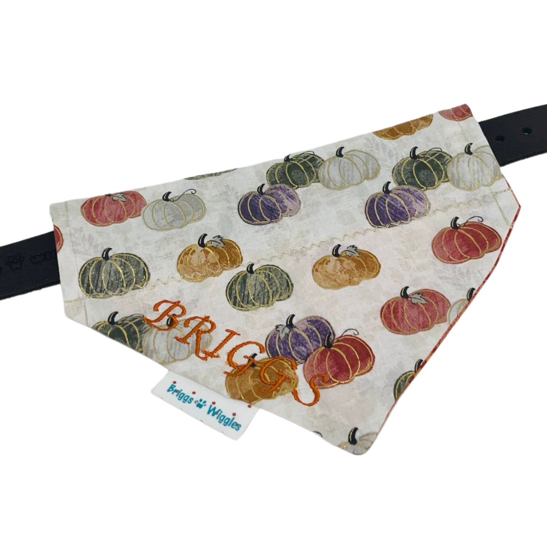 Elegant Fall Pumpkin Dog Bandana laying flat, featuring warm autumn colors and shimmering gold foil outlines, handmade for Thanksgiving and seasonal dog style.