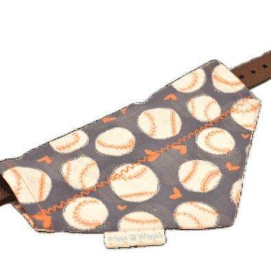 Flat lay of a reversible girly Astros-themed dog bandana with playful orange hearts and baseballs, designed for over the collar or add on scrunchie wear