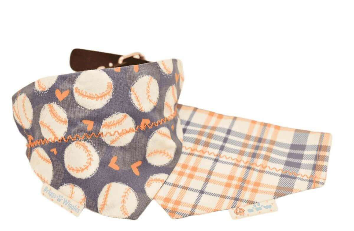 Reversible Astros-inspired girly dog bandana with floating baseballs and orange hearts on one side with a navy background.