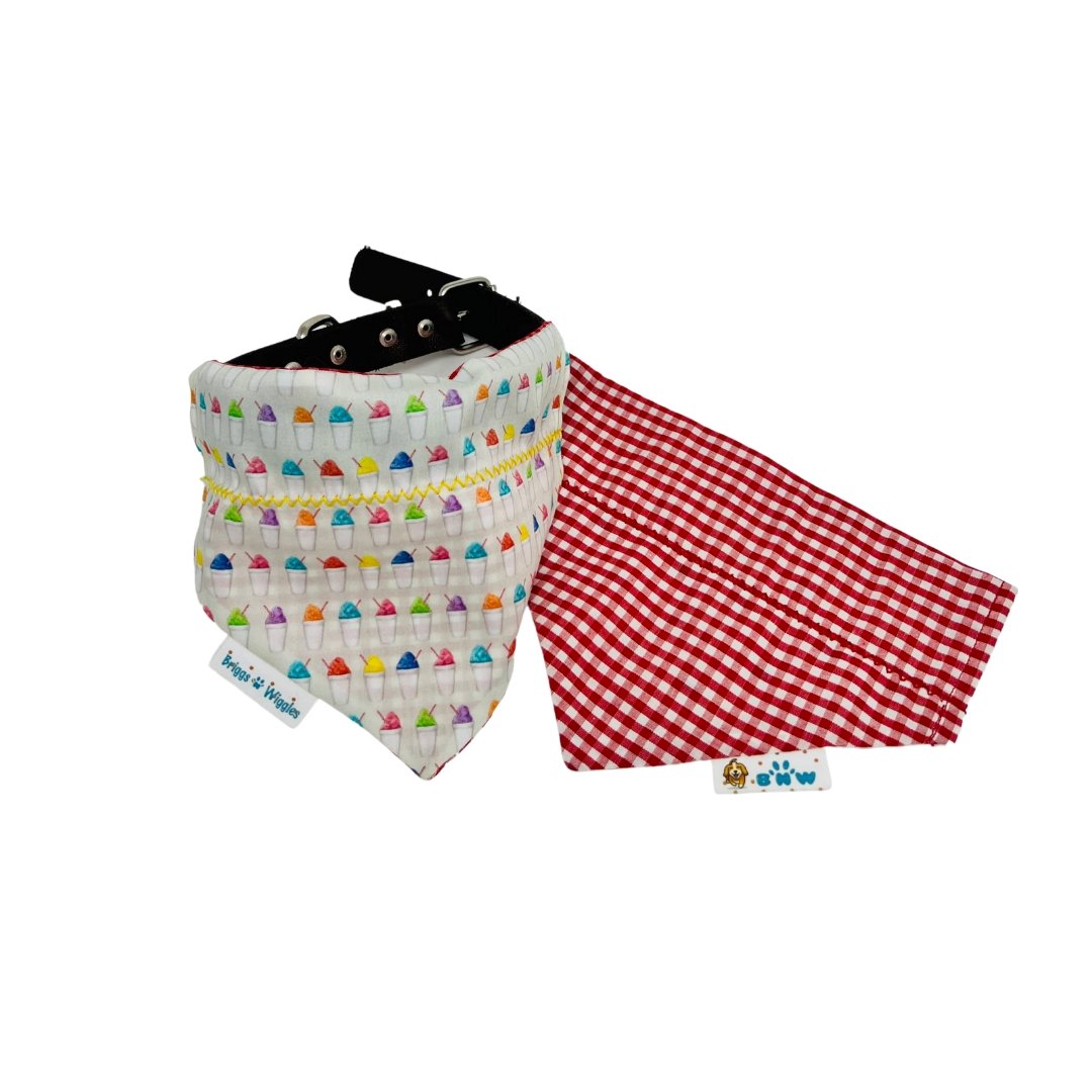 Showcasing both sides of the reversible Snowball Fun Dog Bandana - one side features a colorful snowball pattern, while the other side has a red and white plaid design. Perfect for festive summer adventures.