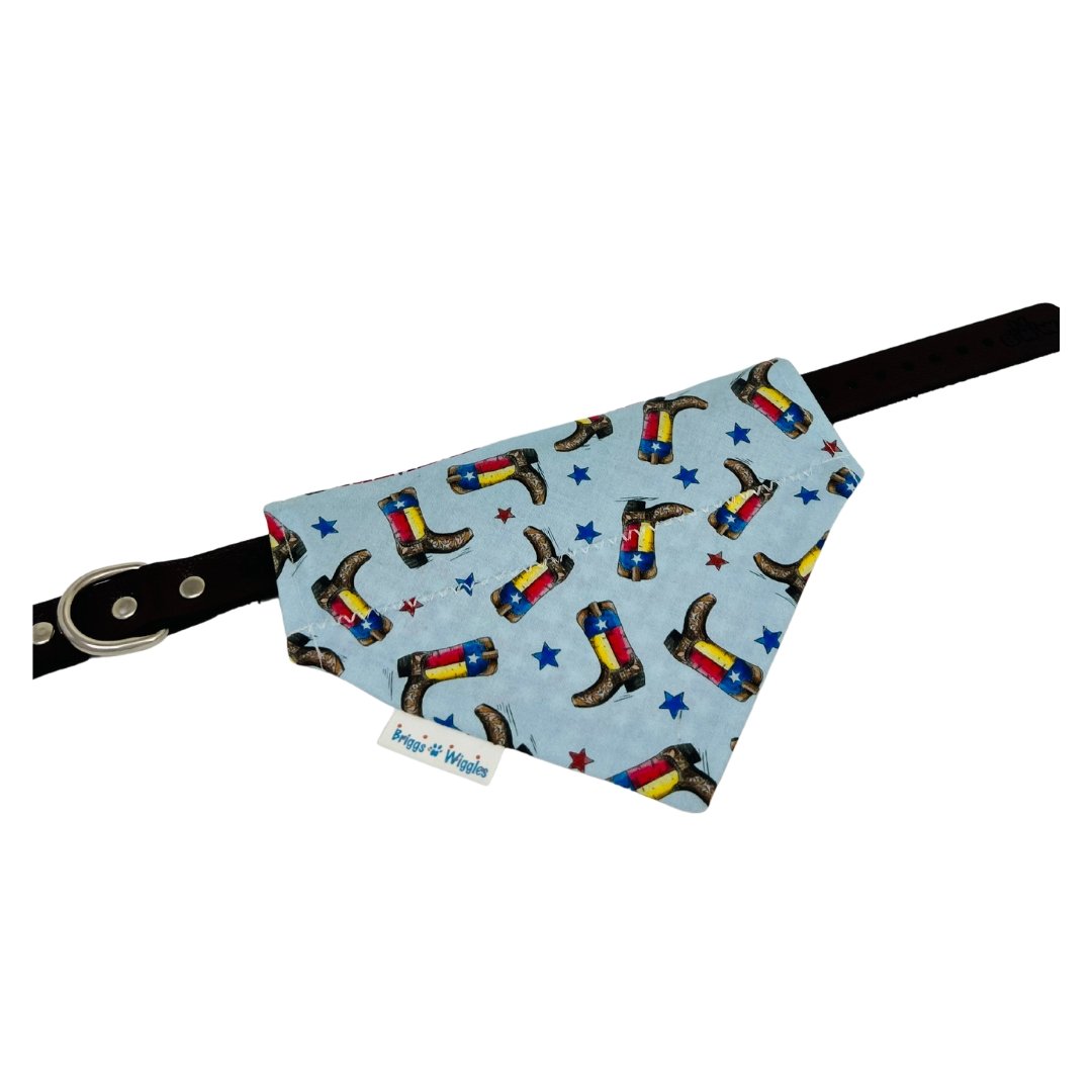 Texas Rodeo Boots Bandana laid flat on a collar, displaying the front side with vibrant floating Texas flag boots and star pattern.