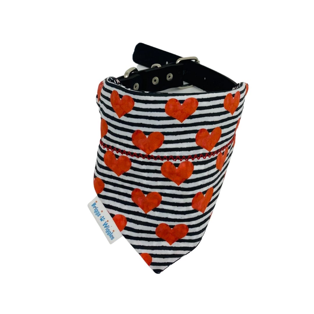 Close-up of black-and-white striped Valentine's Day dog bandana featuring a red heart, ideal for trendy and festive pet accessories.