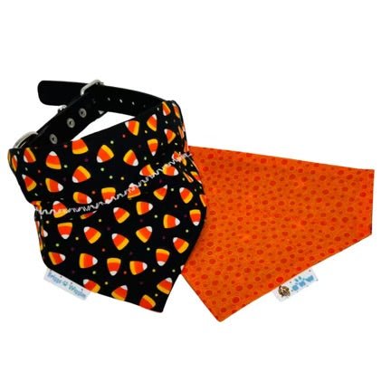 Reversible Candy Corn dog bandana showing front black background with candy corn and colorful polka dots, and reverse side with orange polka dot print, handmade Halloween pet accessory.