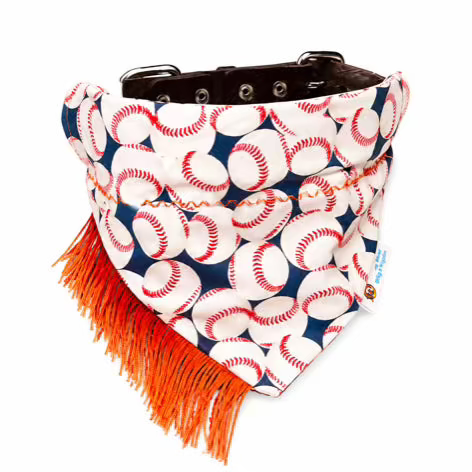 A dog bandana collar featuring a navy blue and white baseball pattern with bright orange fringe, a dark brown collar strap, and silver metal eyelets.